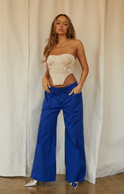 Load image into Gallery viewer, Model Wearing Corset with Blue Pants
