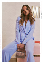 Load image into Gallery viewer, Model Wearing Blue Pants Suit Accessorized With Silver Bag 
