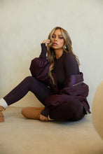 Load image into Gallery viewer, Model Sitting Wearing Chocolate Activewear
