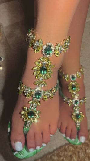 Detail video of model wearing green leaf embellished sandals