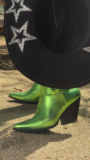 Model wearing green metallic cowgirl boots