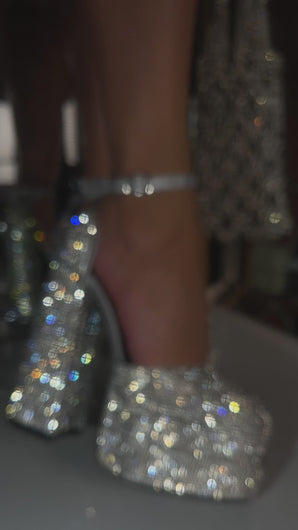 Model wearing silver embellished platform block heels