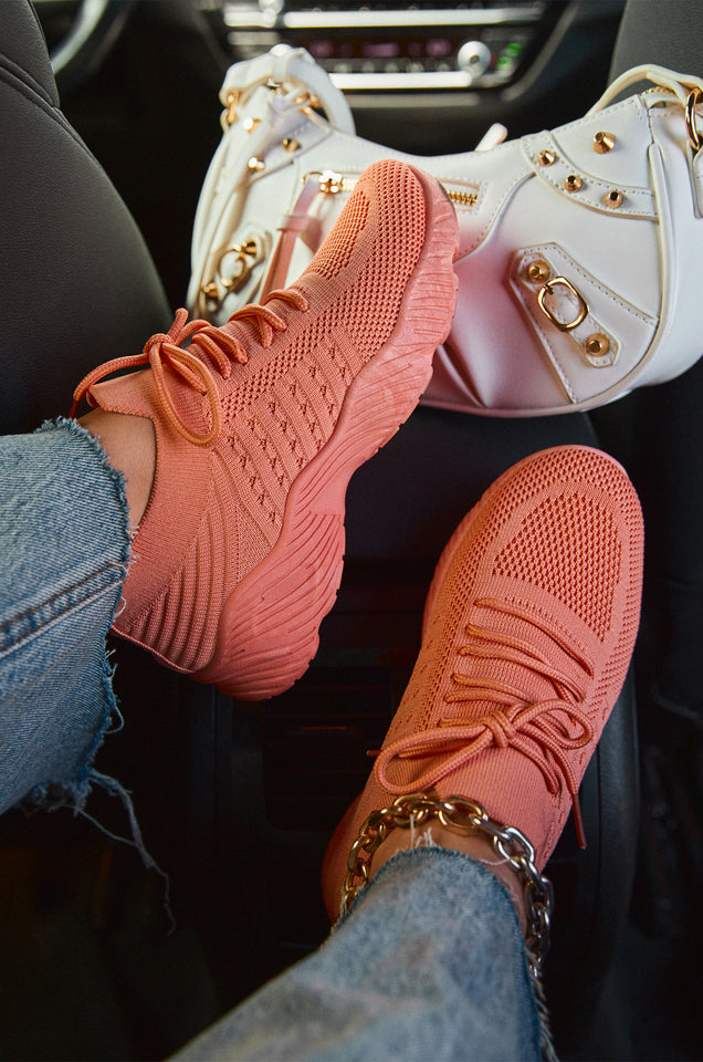 Load image into Gallery viewer, Model Wearing Orange Sneaker 

