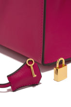 Load image into Gallery viewer, Pink Handbag with Gold-Tone Lock and Key Accessory
