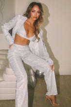 Load image into Gallery viewer, Model Sitting Wearing Silver Pant Set

